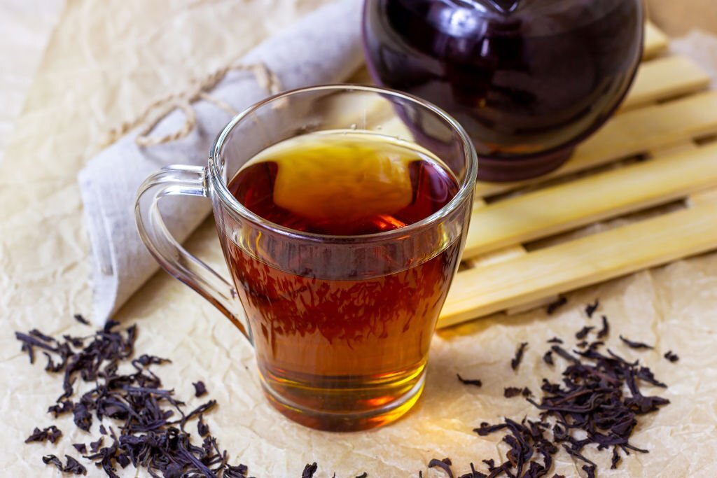 Fresh organic aromatic black tea in the glass cup
